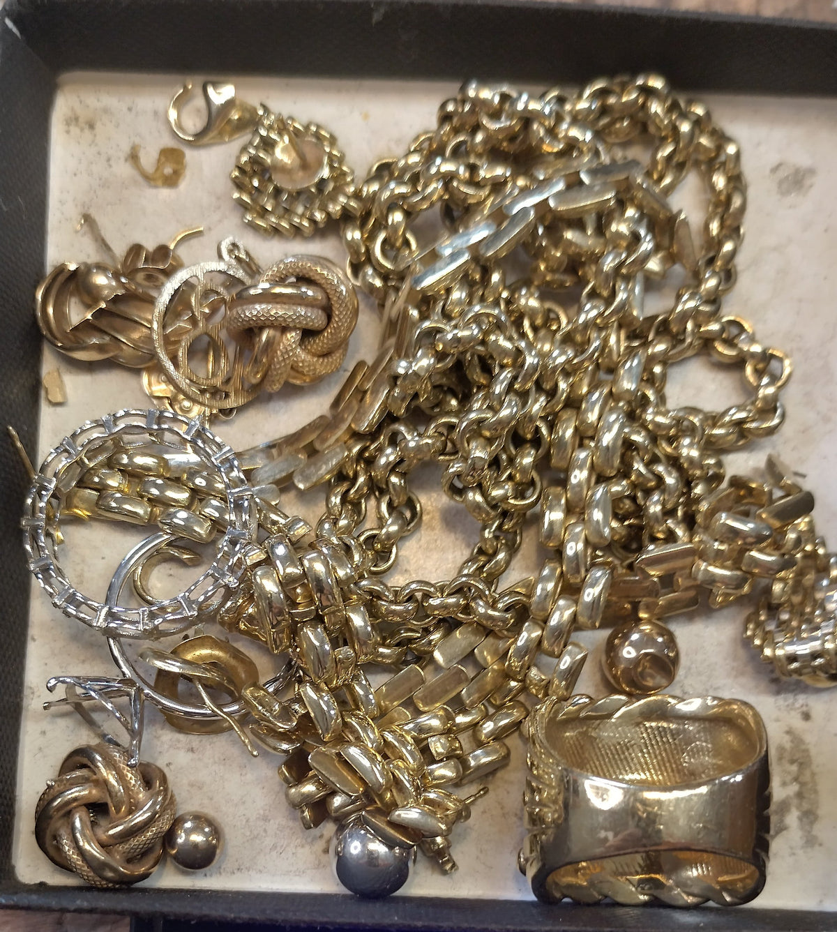 A collection of old gold jewellery, including chains, rings and bracelets, ready to be transformed into new pieces.